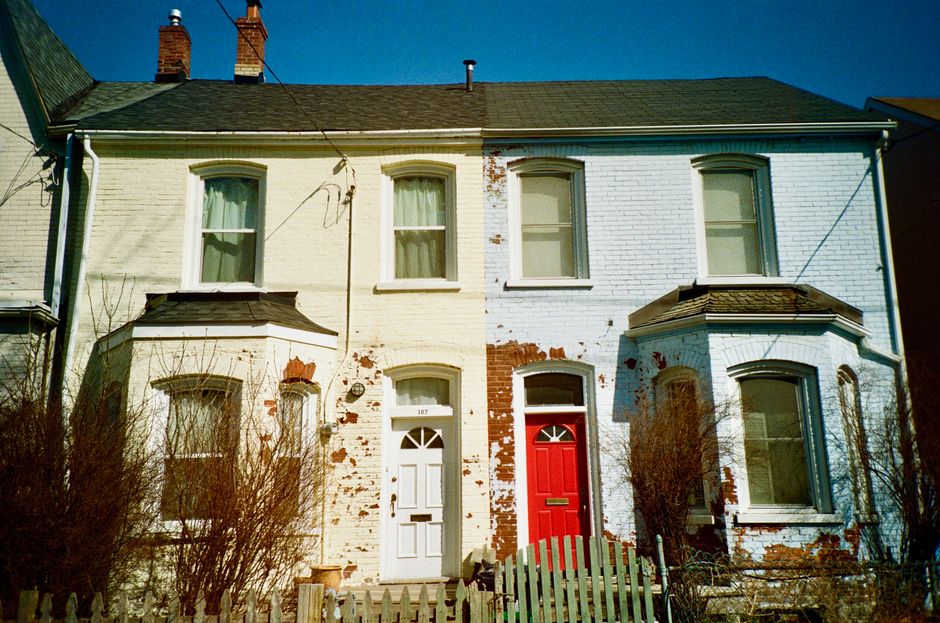 Brick houses with painted red and white doors.